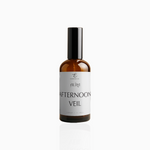 100ml Afternoon Veil fragrance mist in amber glass bottle with black cap and soft grey-white label, photographed on white background