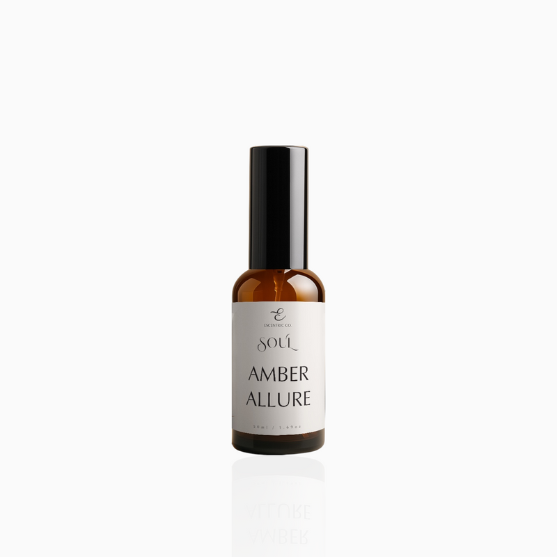 50ml Amber Allure fragrance mist in amber glass bottle with black cap and warm beige label, photographed on white background