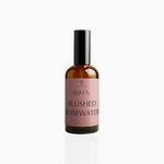 100ml Blushed Rosewater fragrance mist in amber glass bottle with black cap and dusty rose label, photographed on white background