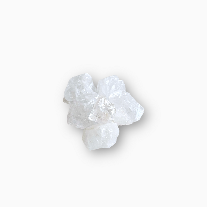 Group of raw Clear Quartz crystals with transparent, icy textures arranged on a clean white background.