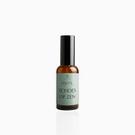 50ml Echoes of Zen fragrance mist in amber glass bottle with black cap and sage green label, photographed on white background