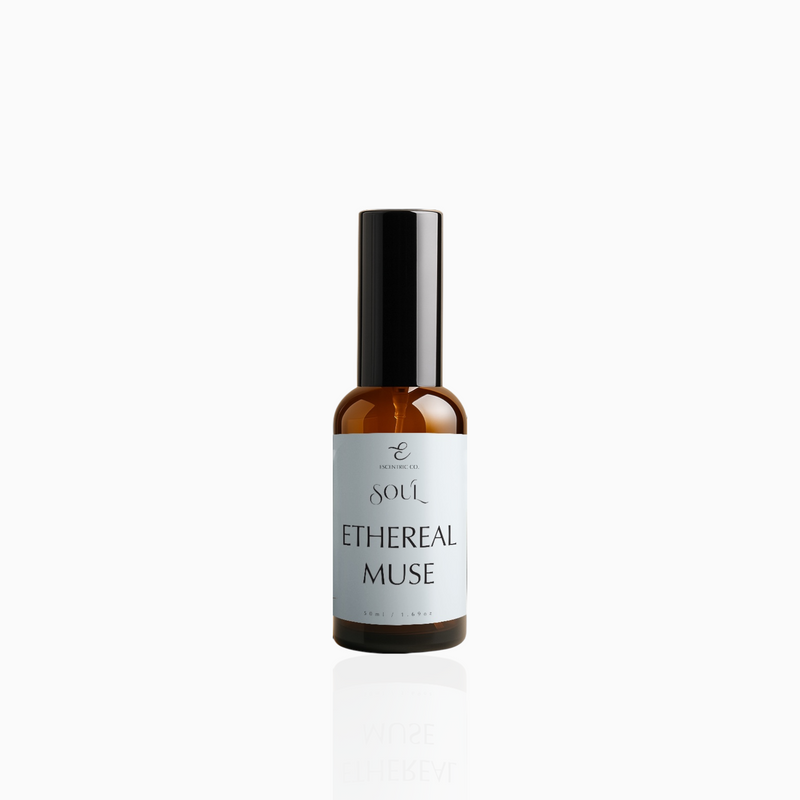 50ml Ethereal Muse fragrance mist in amber glass bottle with black cap and airy powder blue label, photographed on white background