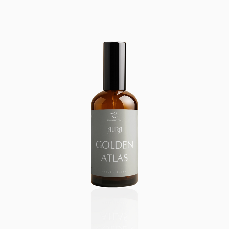 100ml Golden Atlas fragrance mist in amber glass bottle with black cap and muted taupe-grey label, photographed on white background