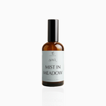 100ml Mist in Meadow fragrance mist in amber glass bottle with black cap and pale mint green label, photographed on white background