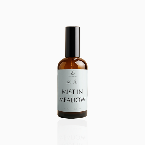 100ml Mist in Meadow fragrance mist in amber glass bottle with black cap and pale mint green label, photographed on white background