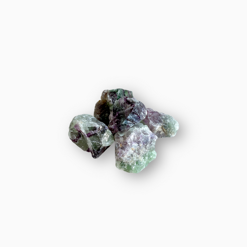 Raw Rainbow Fluorite crystals showcasing layered hues of purple, green, and clear tones, arranged on a clean white background.