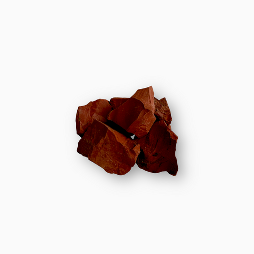 Cluster of raw Red Jasper stones in deep brick red tones, showcasing angular cuts and a matte, unpolished surface, set against a white background.