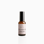 50ml Stillness In Sakura fragrance mist in amber glass bottle with black cap and blush pink label, photographed on white background
