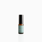 15ml Tranquil Escape fragrance mist in amber glass bottle with black cap and seafoam green label, photographed on white background