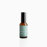 50ml Tranquil Escape fragrance mist in amber glass bottle with black cap and seafoam green label, photographed on white background
