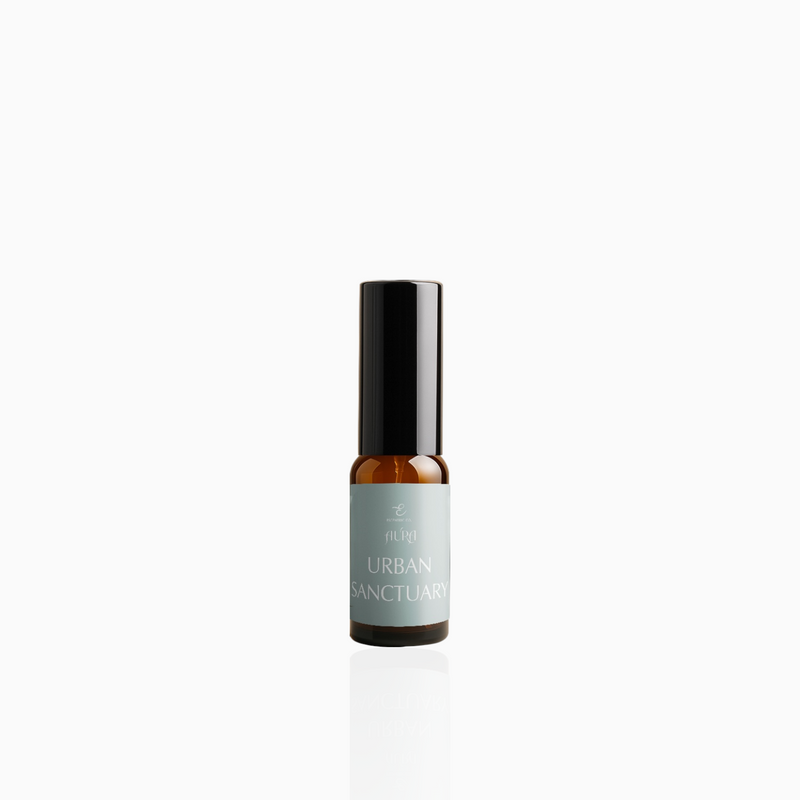 15ml Urban Sanctuary fragrance mist in amber glass bottle with black cap and muted-aqua label, photographed on white background