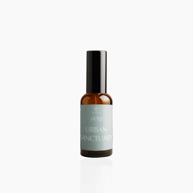 50ml Urban Sanctuary fragrance mist in amber glass bottle with black cap and muted-aqua label, photographed on white background