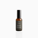 50ml Velvet Reverie fragrance mist in amber glass bottle with black cap and deep grey label, photographed on white background