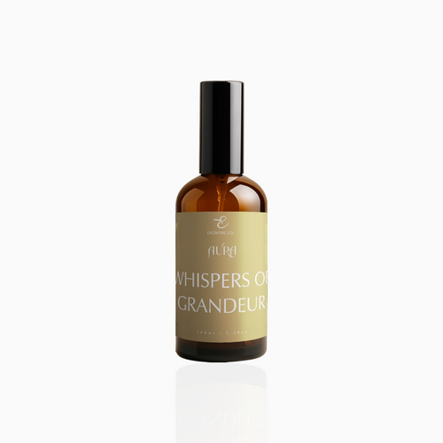 100ml Whispers of Grandeur fragrance mist in amber glass bottle with black cap and muted gold label, photographed on white background