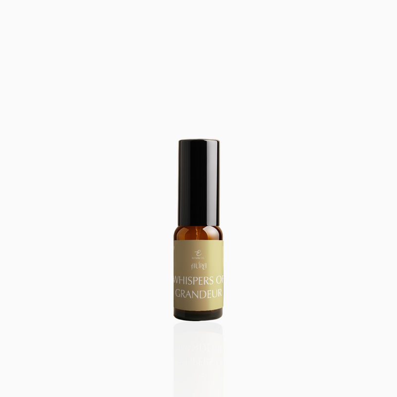 15ml Whispers of Grandeur fragrance mist in amber glass bottle with black cap and muted gold label, photographed on white background