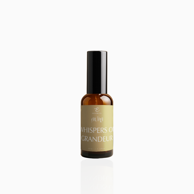 50ml Whispers of Grandeur fragrance mist in amber glass bottle with black cap and muted gold label, photographed on white background
